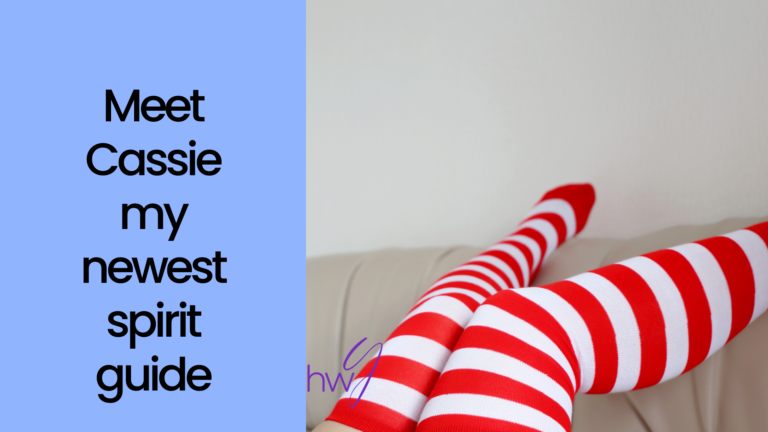 Meet Cassie my newest spirit guide. An image of red and white striped stocking clad legs.